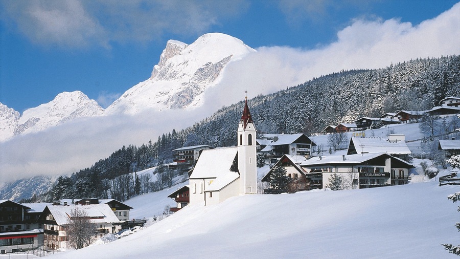 Seefeld in Tirol which includes a small town or village, mountains and a church or cathedral