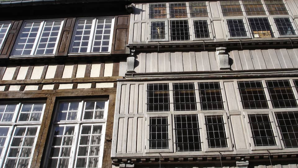 A traditional half-timbered building with multiple windows and a steeply pitched roof.