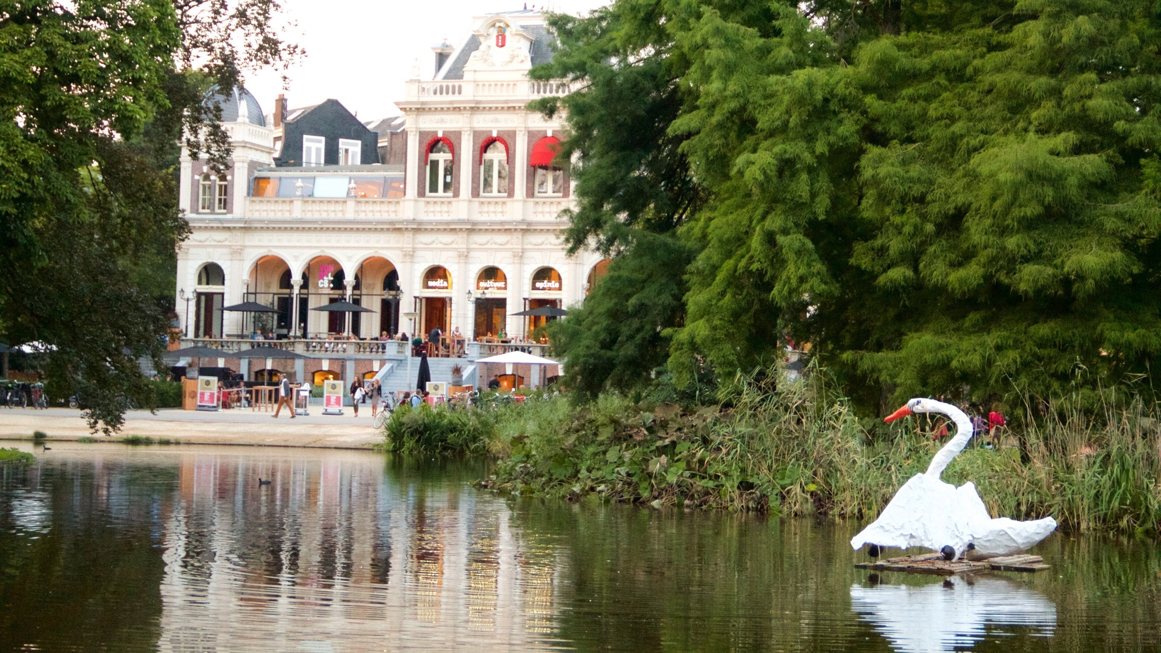 Vondelpark featuring a pond, bird life and heritage architecture