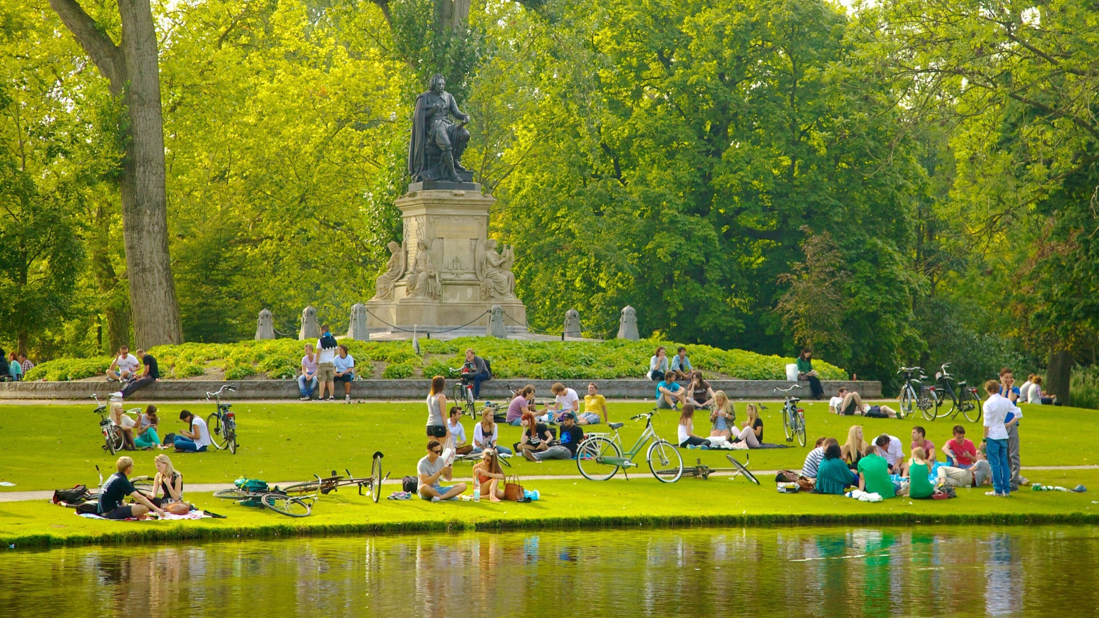 Vondelpark featuring a pond, landscape views and a statue or sculpture
