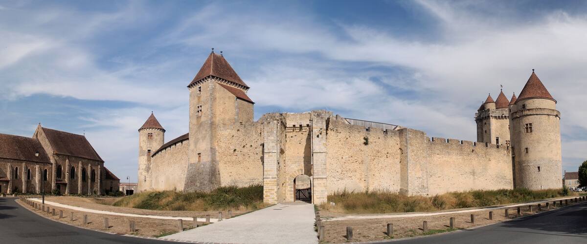 A historic castle with multiple towers and a church.