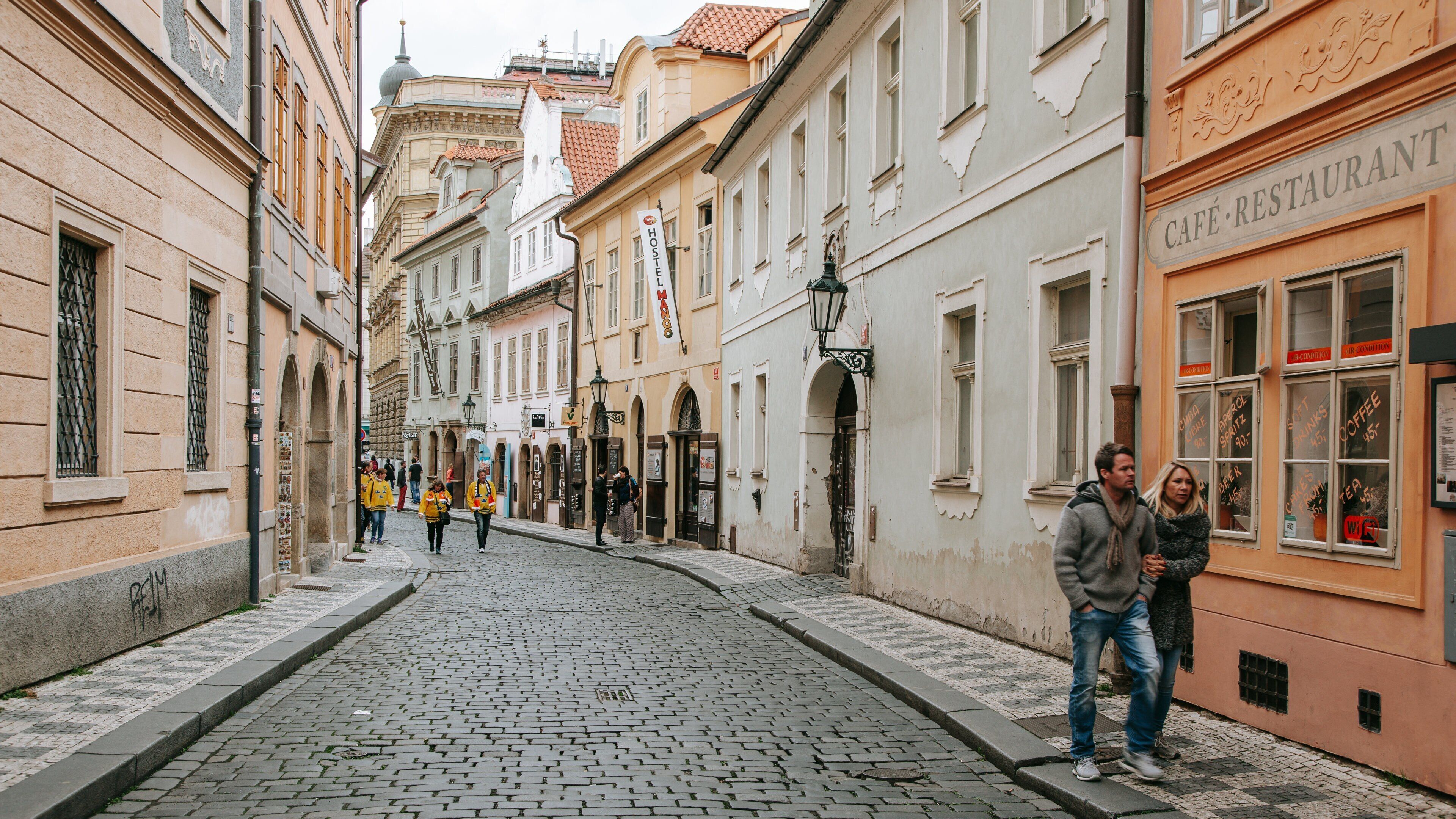 Mala Strana which includes street scenes and a city as well as a couple