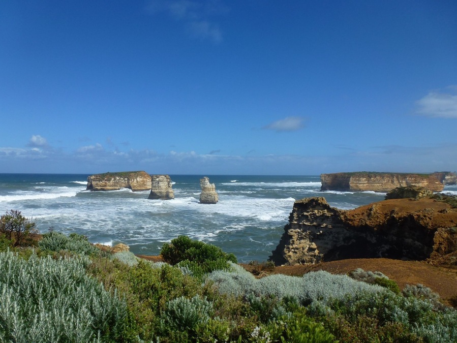 A coastal landscape with prominent rock formations and rugged cliffs.