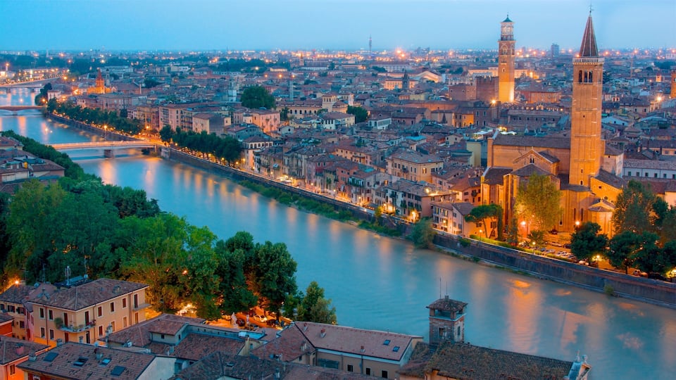 A river winding through a historic city with a prominent tower and a bridge.