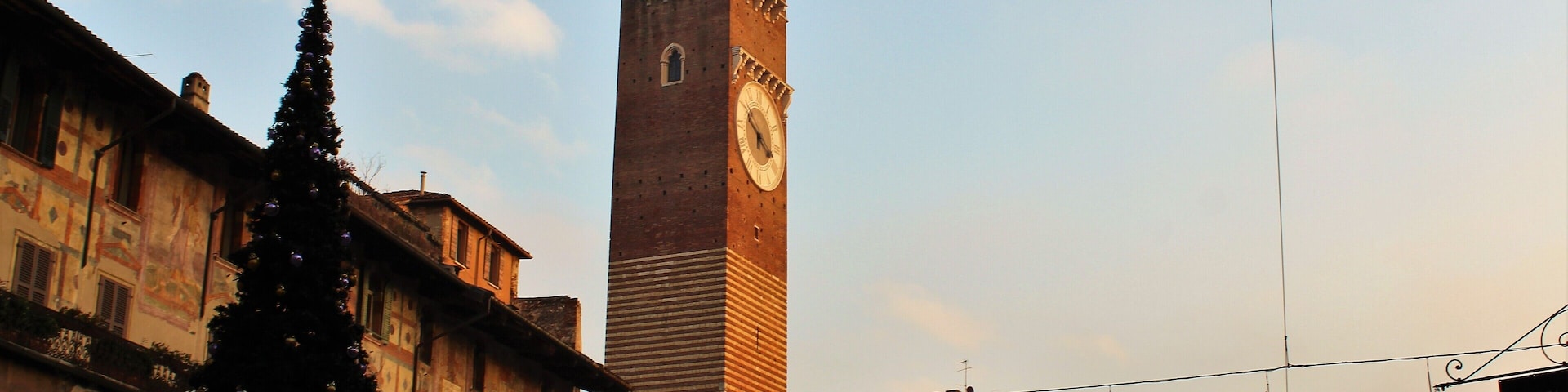 The iconic Lamberti Tower in Verona! Construction started in 1172. In May 1403 the top of the tower was struck by lightning, but the restoration works didn't start until 1448 and took 16 years. During that time, the tower was enlarged: The more recent sections can be recognized today by the use of different materials (such as marble). The large clock was added in 1779. At 84 meters high it's a really impressive sight!
I took this photo in December 2017.