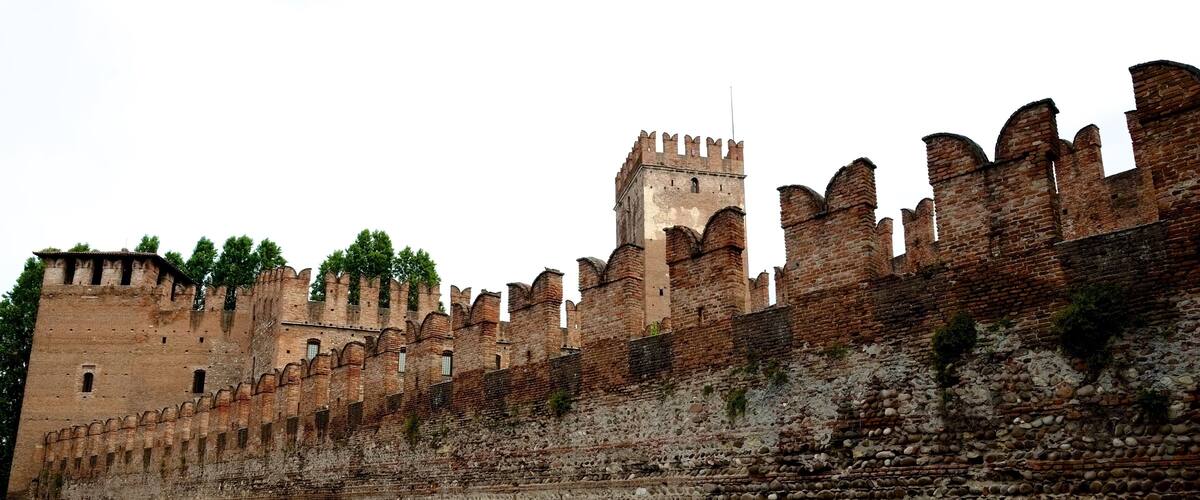 On the banks of the Adige, Castelvecchio was built by the Scaligeri in 1354-55, an impressive defensive fortress certain to remind any rivals of the power of the della Scala family. Crossing the river is the beautiful castellated Ponte Scaligero, a 14th-century bridge that's traffic free and a favorite stroll for local families. The castle's main tower and ramparts afford views of the bridge, the city, and surrounding hills. The castle interior has been brilliantly restored and transformed into bright exhibit space by architect Carlo Scarpa, without sacrificing the integrity or history of the castle. The collections of the Civico Museo d'Arte are shown here, featuring Veronese sculpture, applied art, and paintings, with works by Bellini, Rubens, Montagna, Guardi, Tiepolo, Tintoretto, Pisano, and artists of the 15th- and 16th-century Veronese school. A few steps up Corso Cavour is the Arco dei Gavi, a first-century stone arched gate that spanned a Roman road; look for the grooves worn by chariot wheels in the stone below the arch.