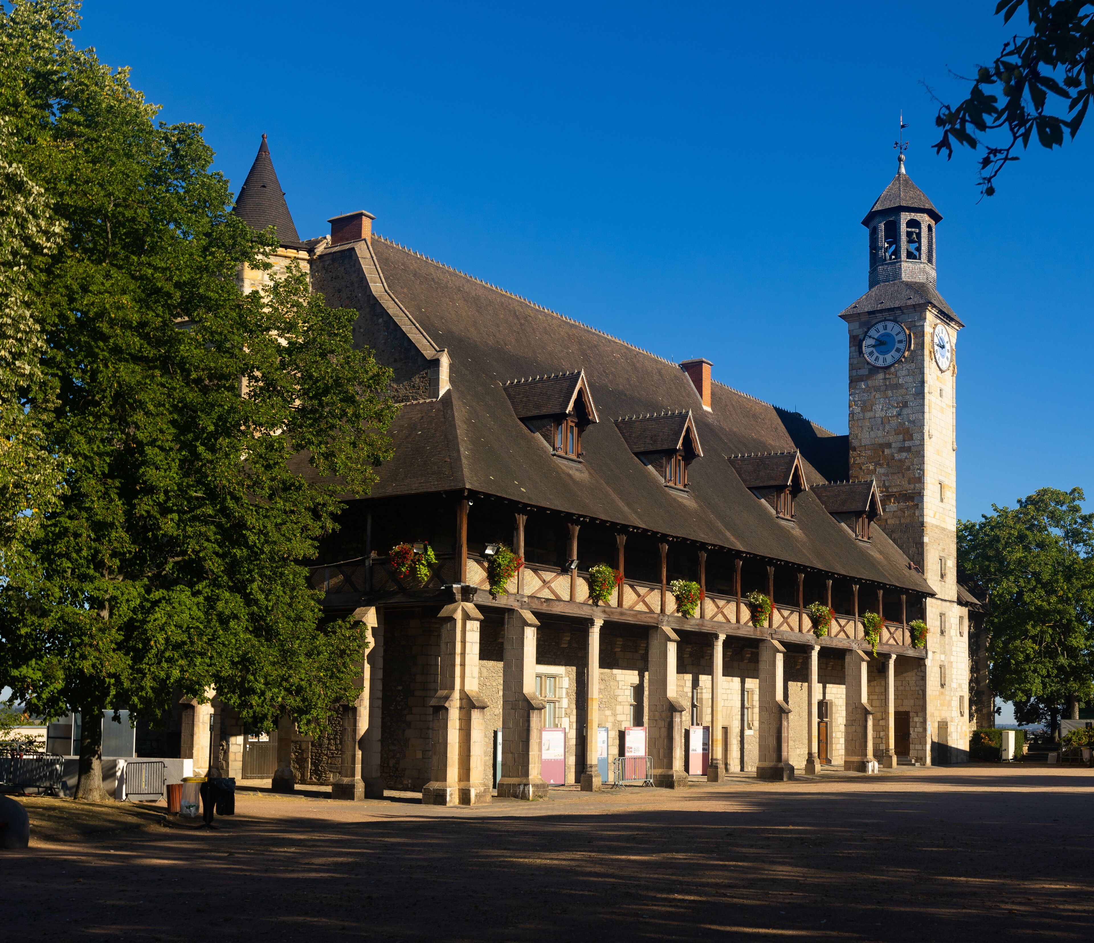 A historic building with a clock tower and a covered walkway.
