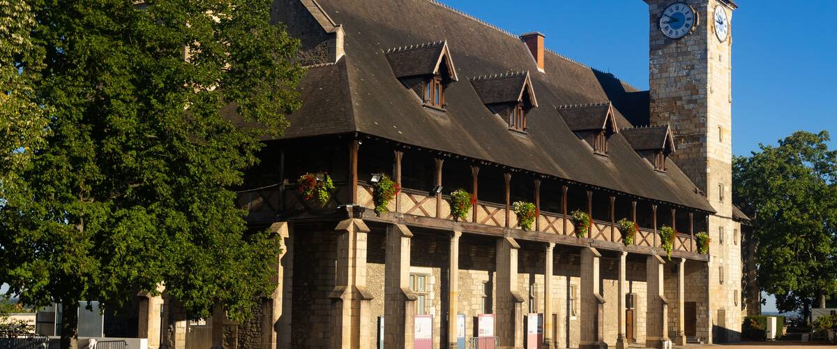 A historic building with a clock tower and a covered walkway.
