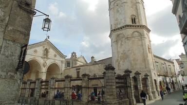 A historic building with a bell tower and arched windows.