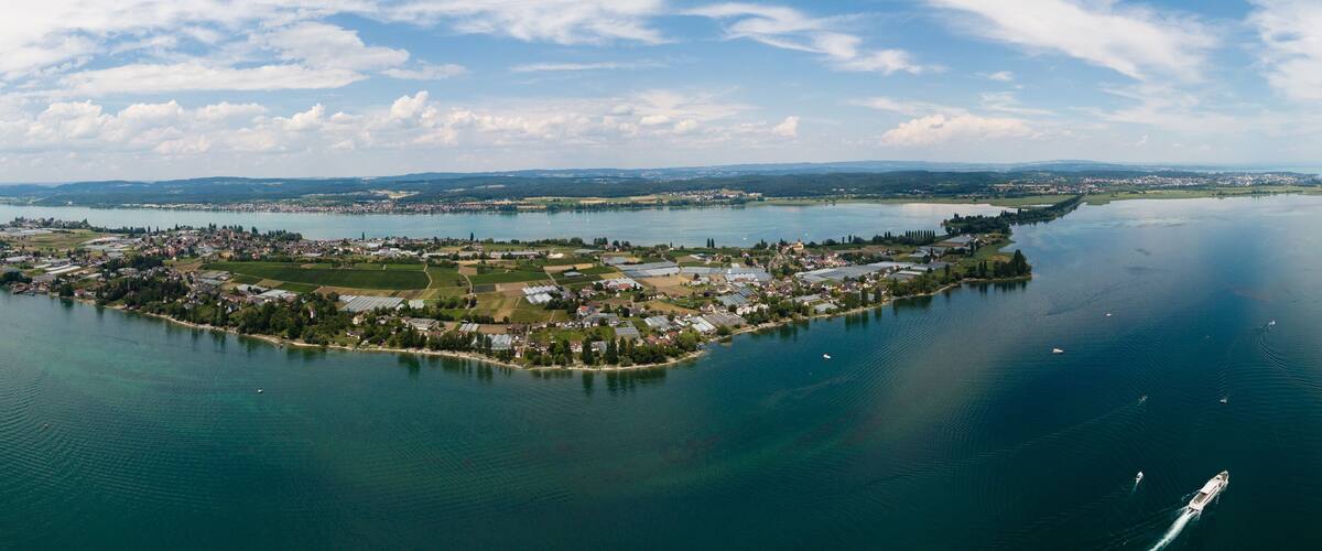 An aerial view of a small island with a dense cluster of buildings surrounded by water.