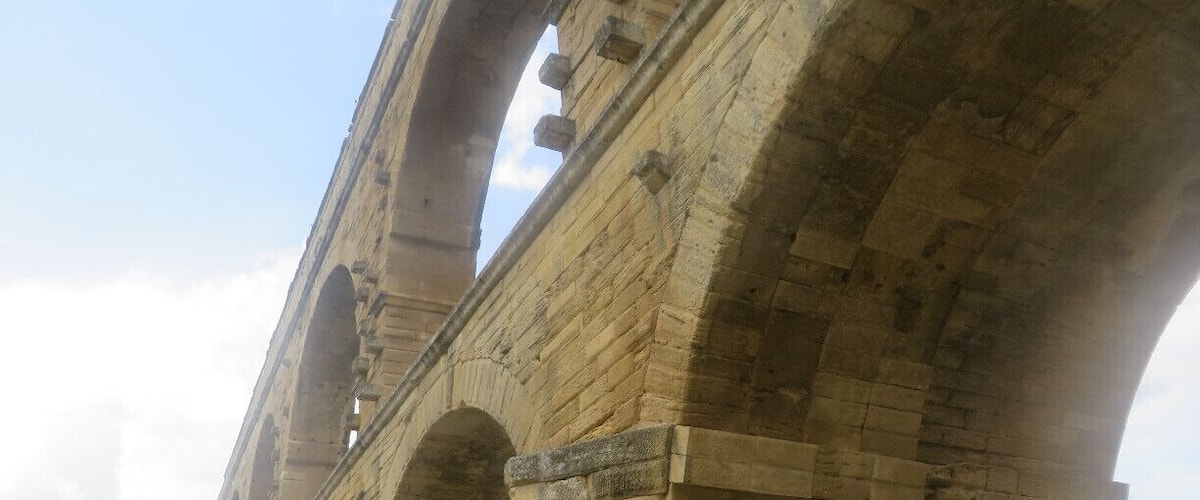 A stone bridge with multiple arches and a river beneath.