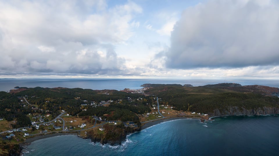 Aerial view of a small town on a rocky Atlantic Ocean Coast during a cloudy day. Taken in Paradise, Twillingate, Newfoundland, Canada.