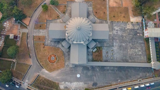 Aerial view of urban landscape featuring modern buildings, a dome, roads, and greenery, Owerri Municipal, Nigeria.