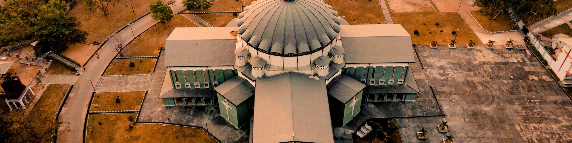 Aerial view of the beautiful Assumpta Cathedral with its historic dome surrounded by urban landscape and greenery, Owerri, Nigeria.