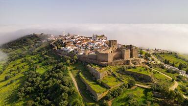 Monsaraz drone aerial view on the clouds in Alentejo, Portugal