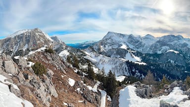 A snow-covered mountain range with a lake in the valley.