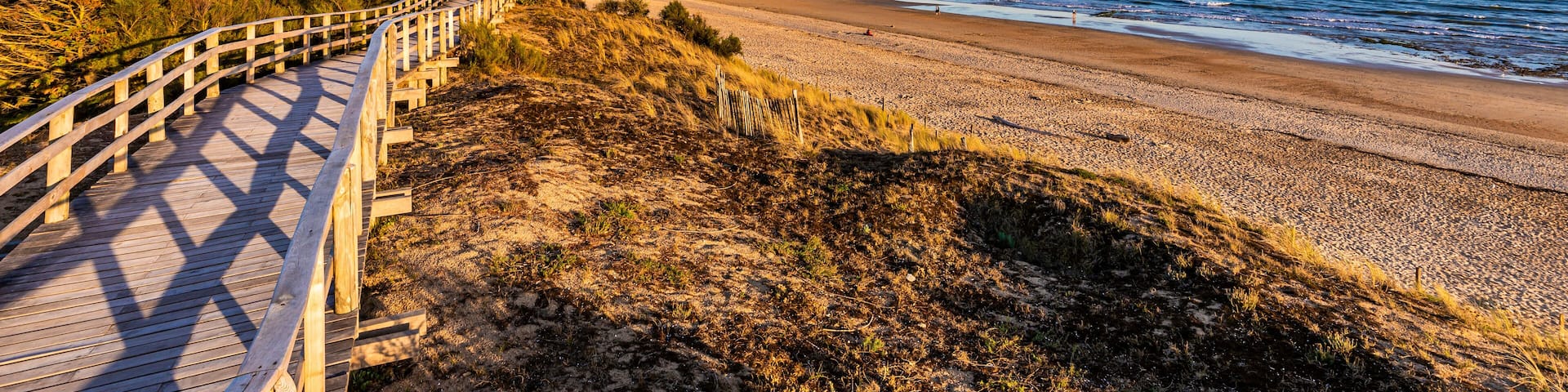 France, Nouvelle-Aquitaine, Le Bois-Plage-en-Re, Panoramic view of empty beachside boardwalk