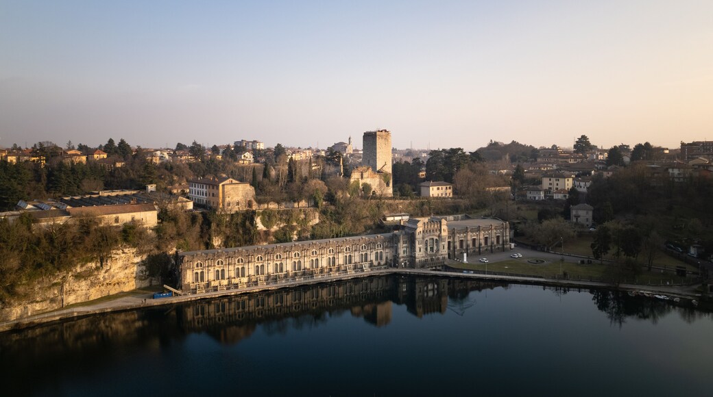 Aerial view over the city of Trezzo sull'Adda with the hydroelectric power plant in the foreground with the castle behind it.