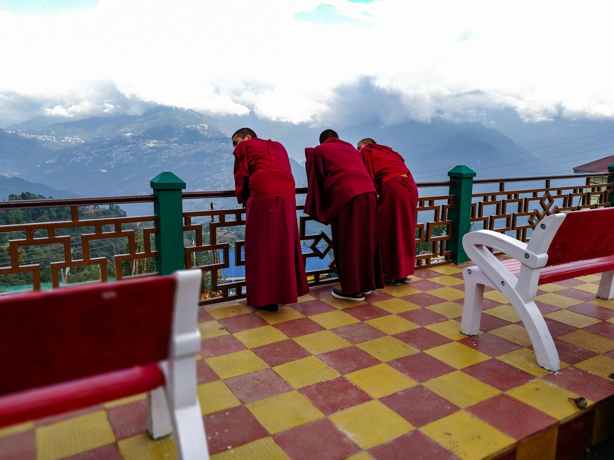 While they are not chanting for prayers, which we found takes 4-5 hours in afternoon, monks in red relax in picturesque surroundings of the Rumtek monastery. #redphotosweepstakes #red
