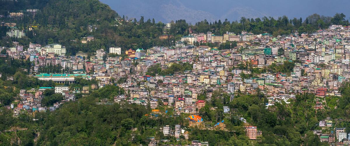 A densely packed hillside settlement with colorful buildings.