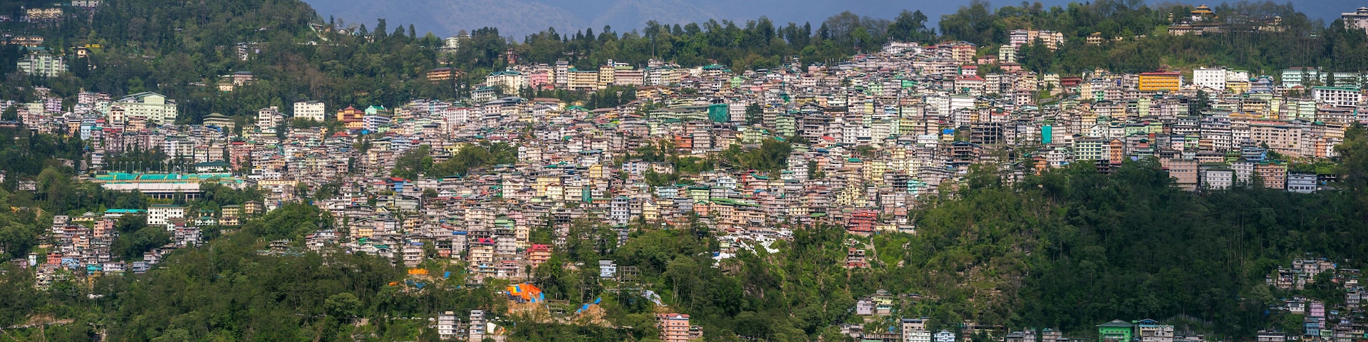 A densely packed hillside settlement with colorful buildings.