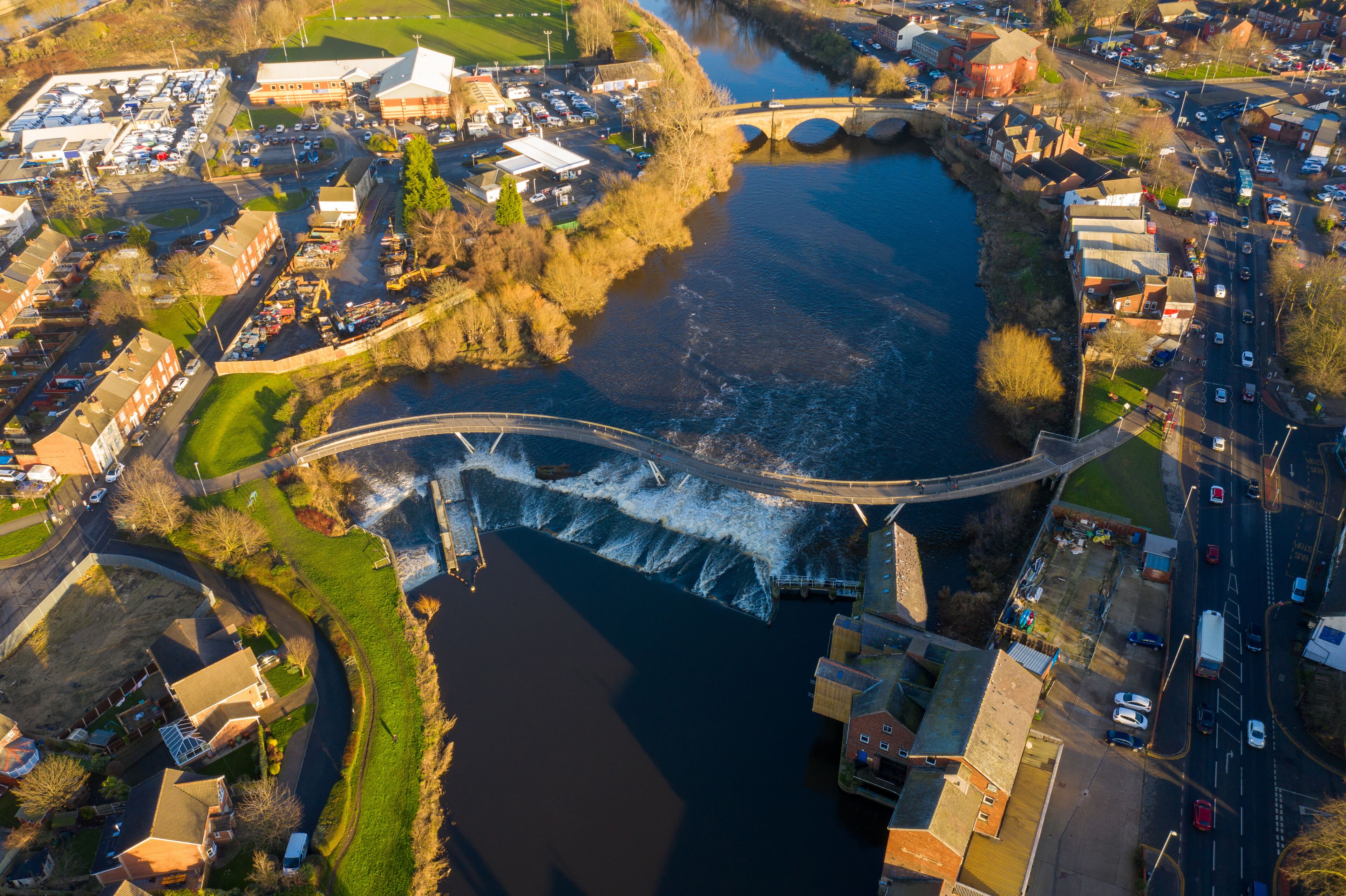 Aerial photo of the village centre of Castleford in Wakefield, West Yorkshire, England showing the main street along side the River Aire on a sunny day in the Autumn time