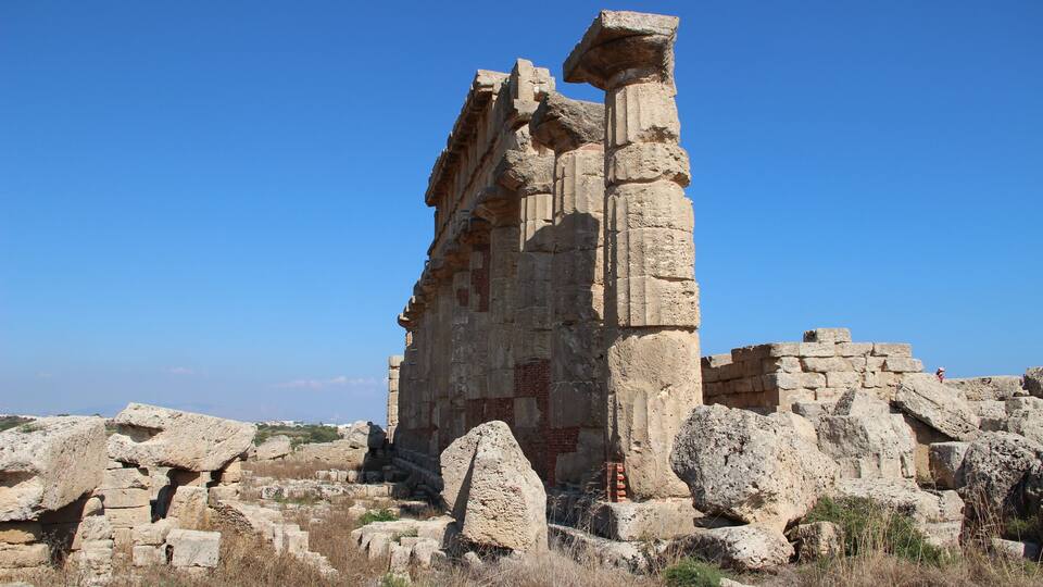 Ancient ruins with large stone blocks and columns.