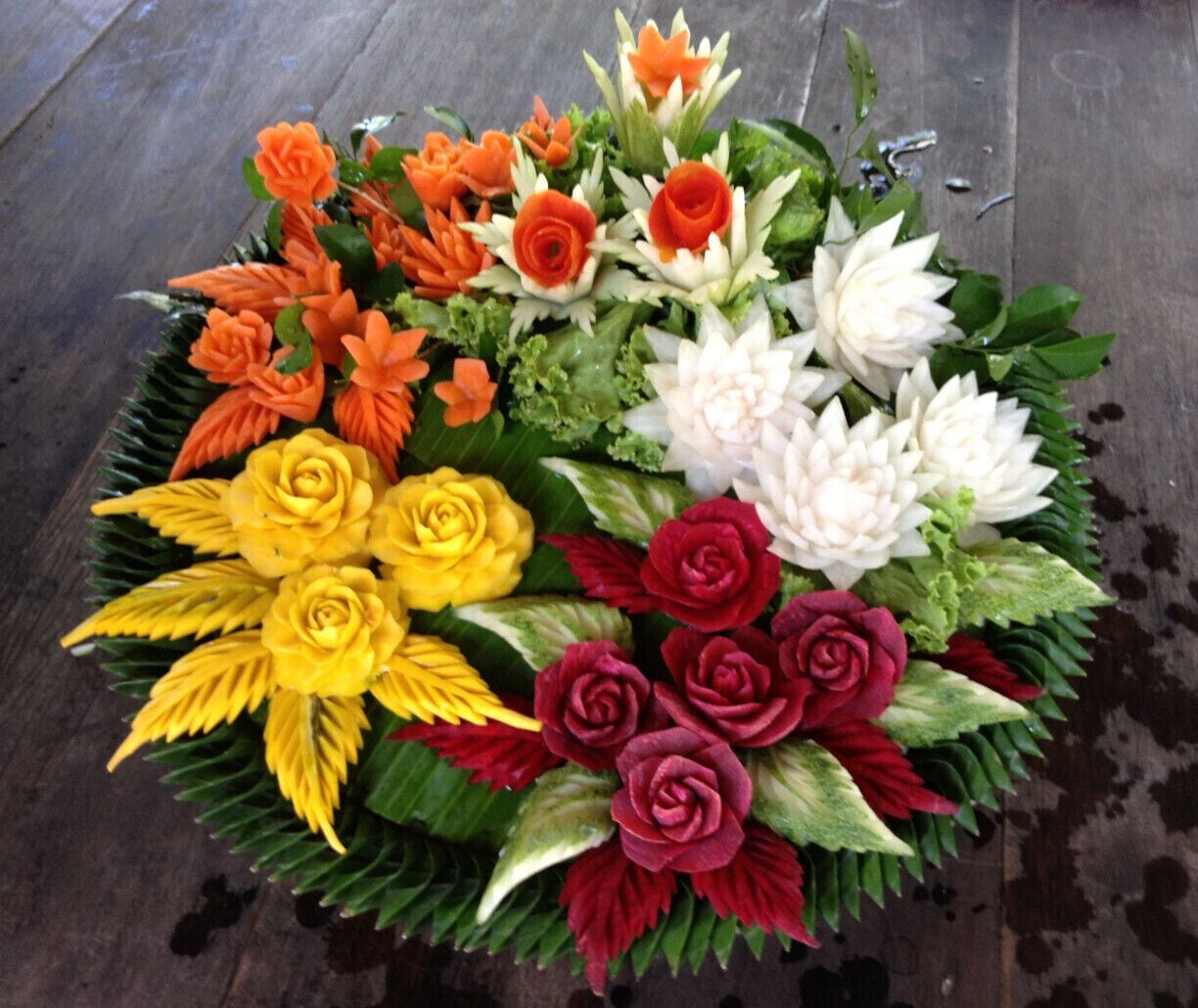 Colorful flowers are made of carrots, pumpkin, beet root and white onions, while the leaves made of cucumber. Vegetable carving is one of the attractions/things to do for visitors of formerly Rose Garden Riverside and now Sampran Riverside, activities to promote Thai living or culture. The visitors can watch how it is done or can try by themselves.  