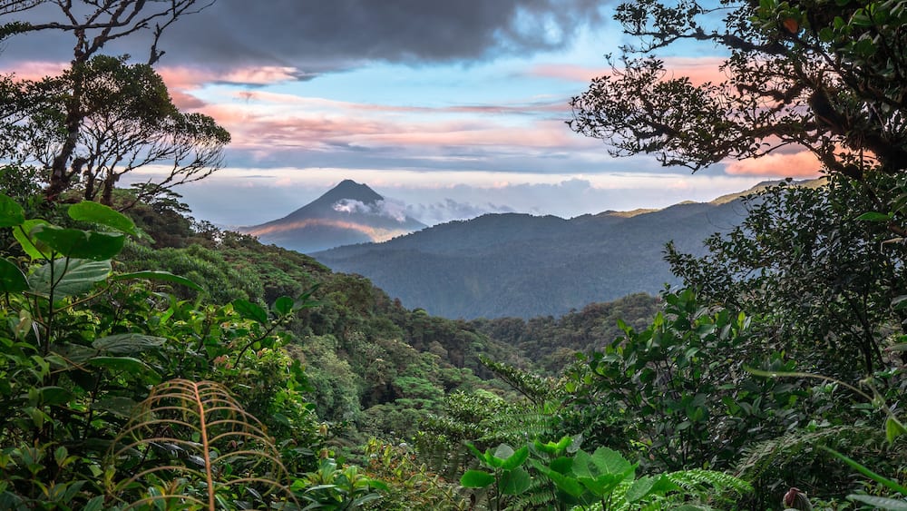 Volcan Arenal dominates the landscape during sunset, as seen from the Monteverde area, Costa Rica.