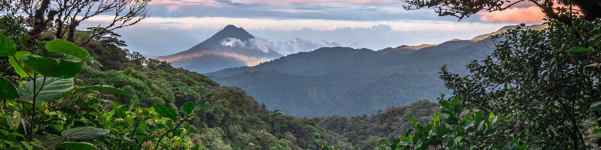 Volcan Arenal dominates the landscape during sunset, as seen from the Monteverde area, Costa Rica.