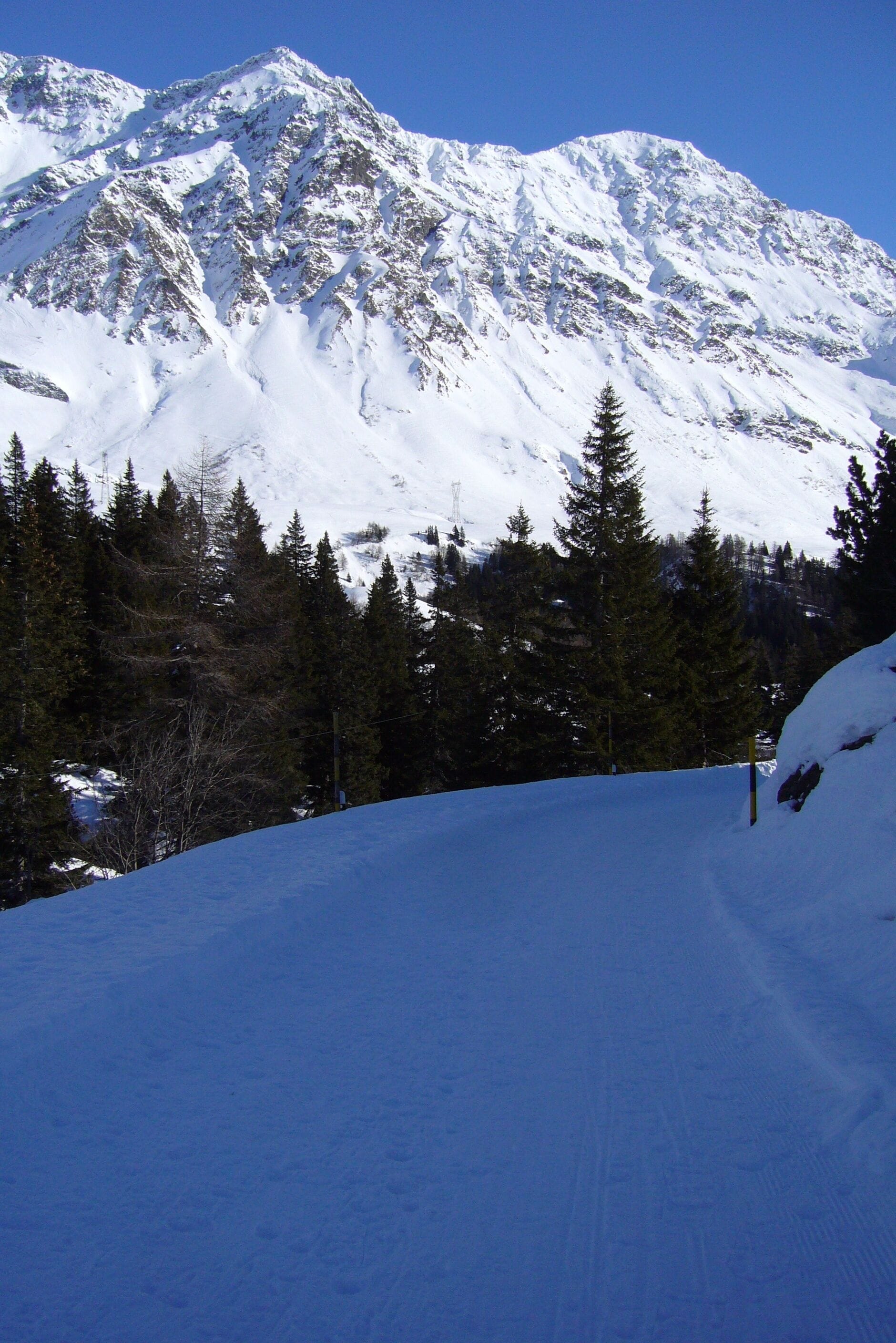 A snow-covered mountain with a clear sky.