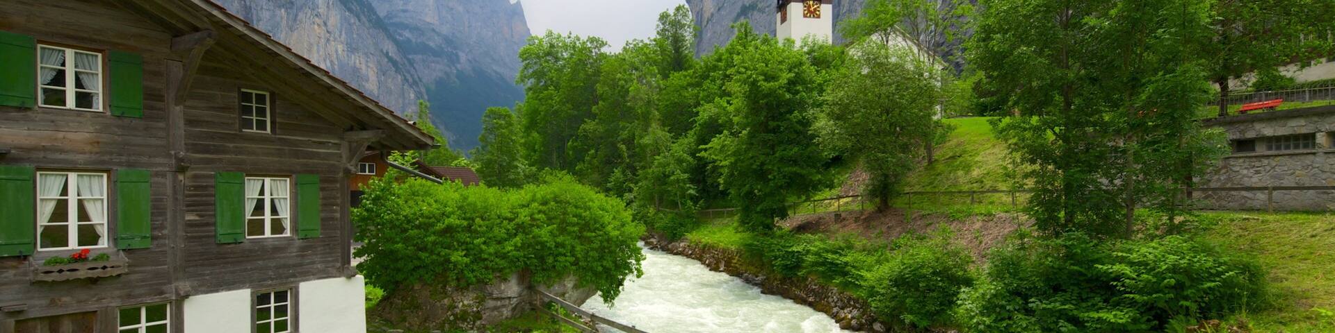 Lauterbrunnen which includes heritage architecture, mountains and a river or creek