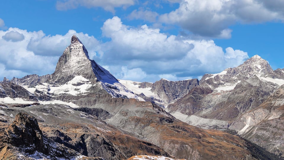A mountain range with a prominent peak and snow-covered slopes.
