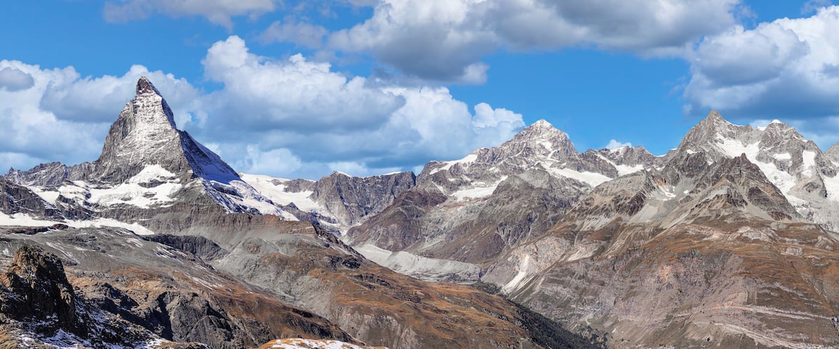 A mountain range with a prominent peak and snow-covered slopes.