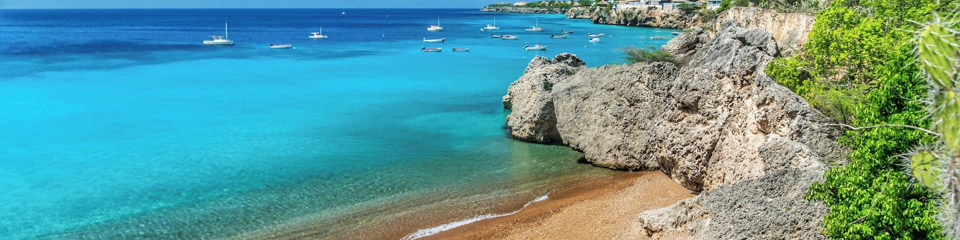 Small beach where fishing boats come in. Fish are cleaned and remains fed to the turtles. You can snorkel around the beach any time of day and see many turtles