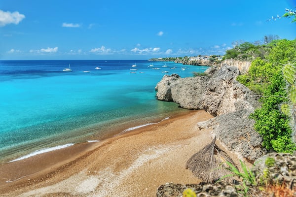 Small beach where fishing boats come in. Fish are cleaned and remains fed to the turtles. You can snorkel around the beach any time of day and see many turtles
