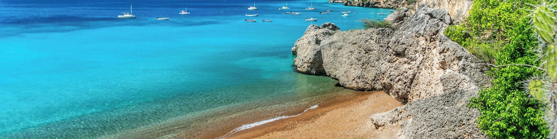 Small beach where fishing boats come in. Fish are cleaned and remains fed to the turtles. You can snorkel around the beach any time of day and see many turtles