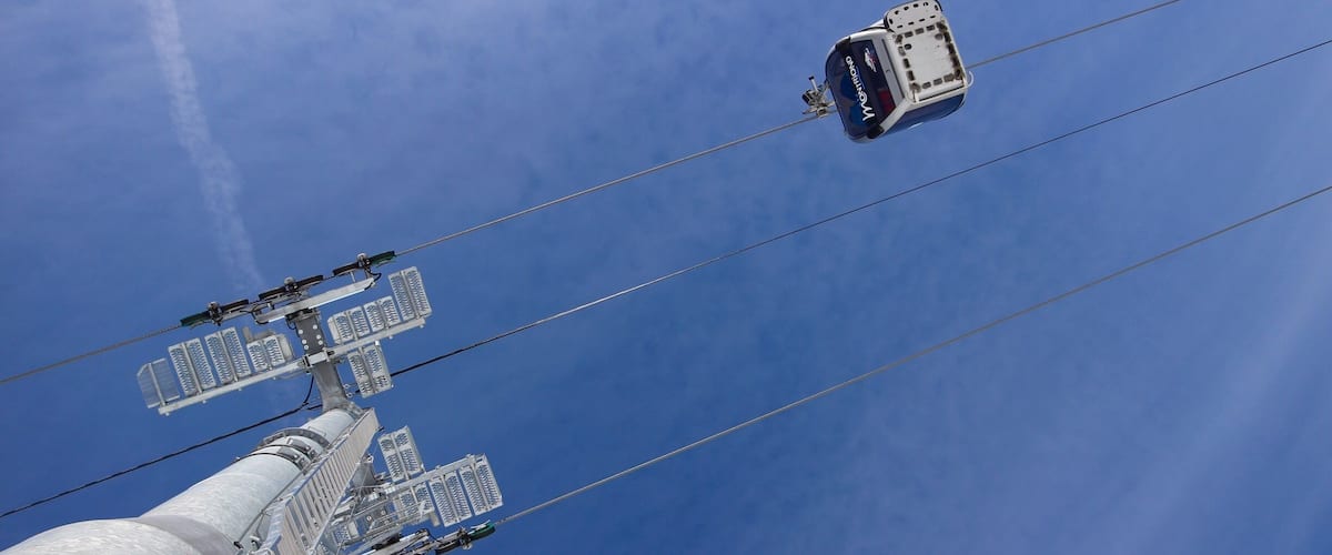 A cable car system with a cable car suspended between two towers.