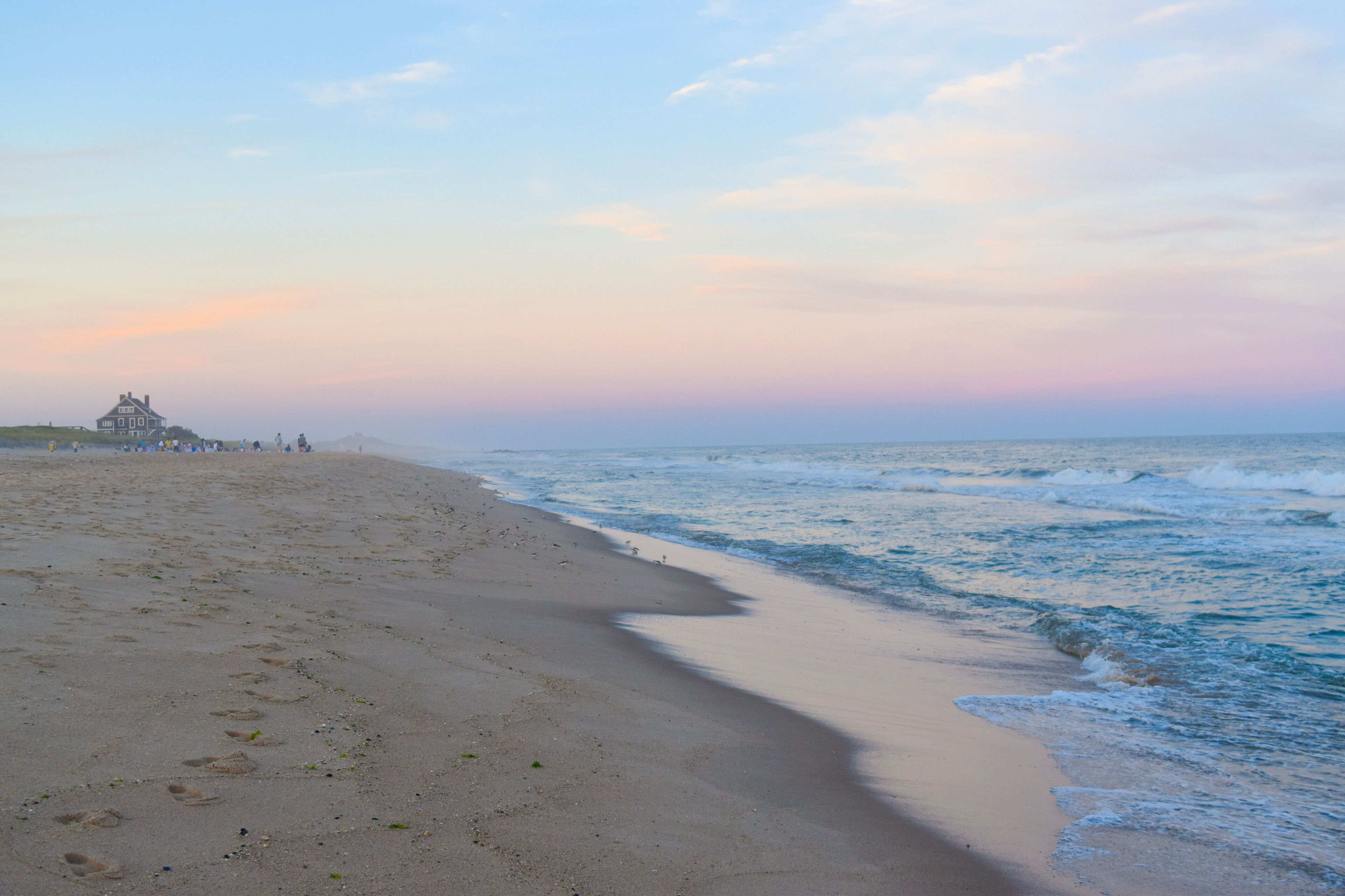sunset on the beach in the Hamptons with a cotton candy colored sky