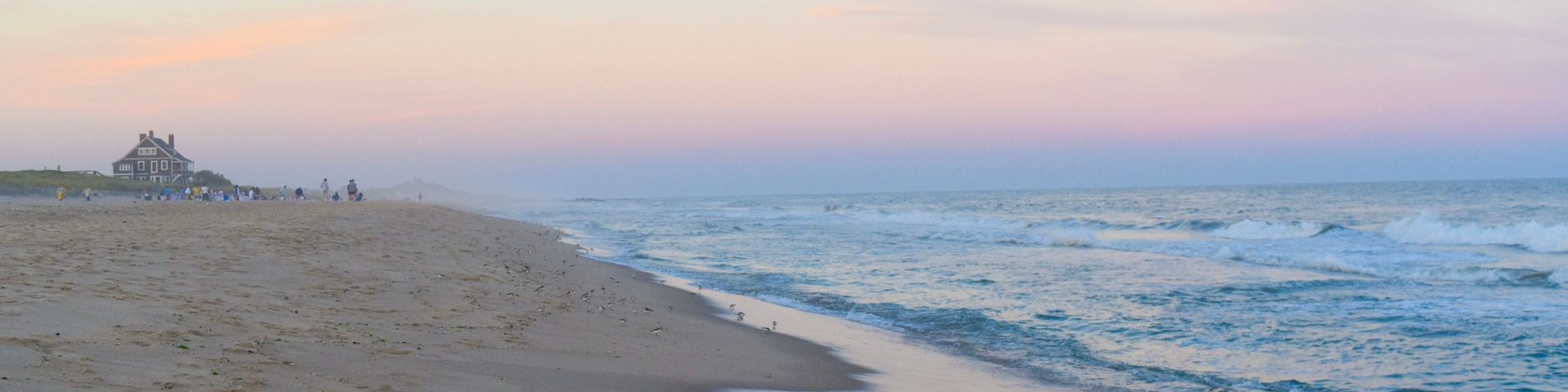 sunset on the beach in the Hamptons with a cotton candy colored sky