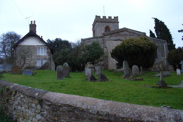 Weedon Lois, Northamptonshire: the Church of England parish church of St Mary and St Peter (right) and a cottage (left).