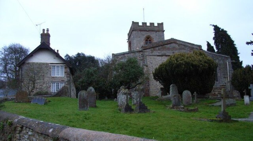 Weedon Lois, Northamptonshire: the Church of England parish church of St Mary and St Peter (right) and a cottage (left).