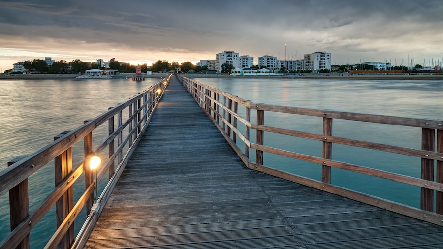 Looking at Lignano Sabbiadoro from wooden pier at sunset