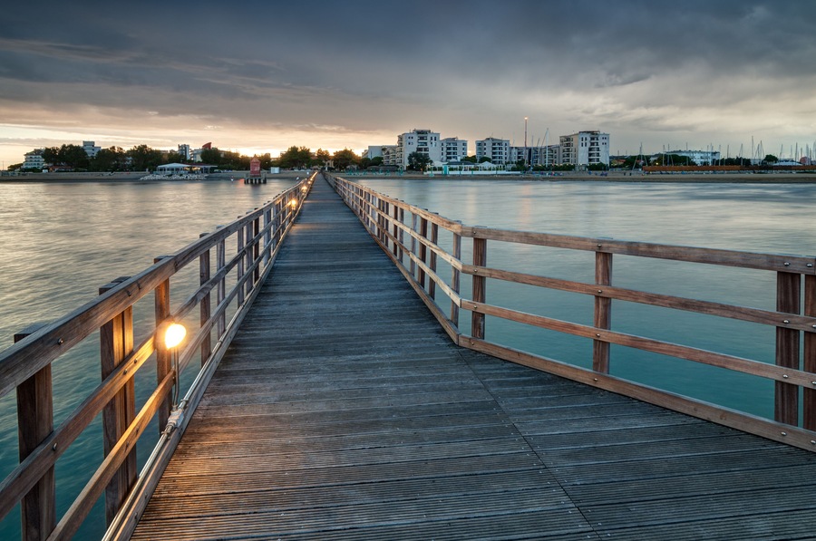 Looking at Lignano Sabbiadoro from wooden pier at sunset