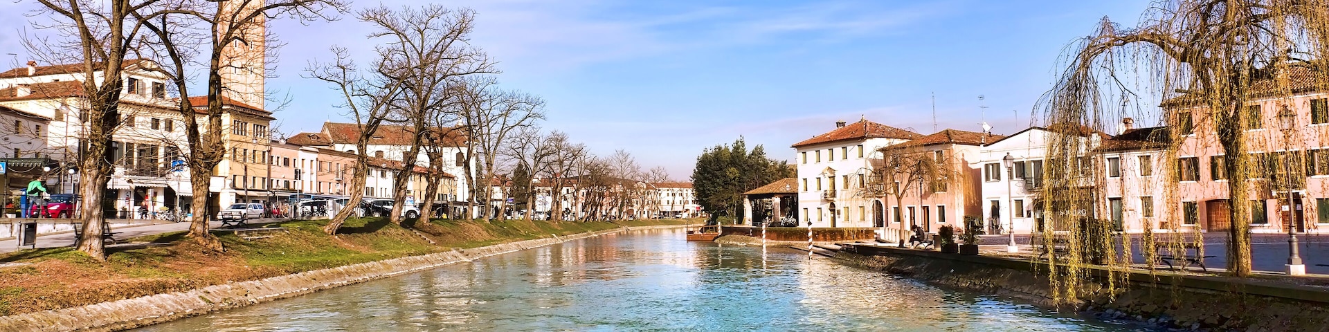 A river with buildings and a tower on the left.
