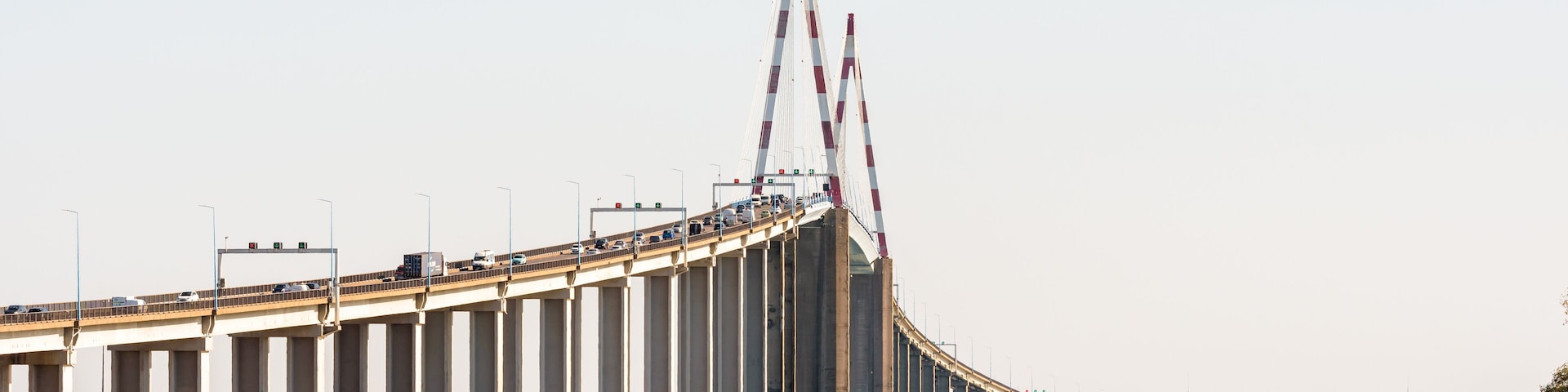 A large bridge with multiple lanes of traffic, spanning over a body of water.