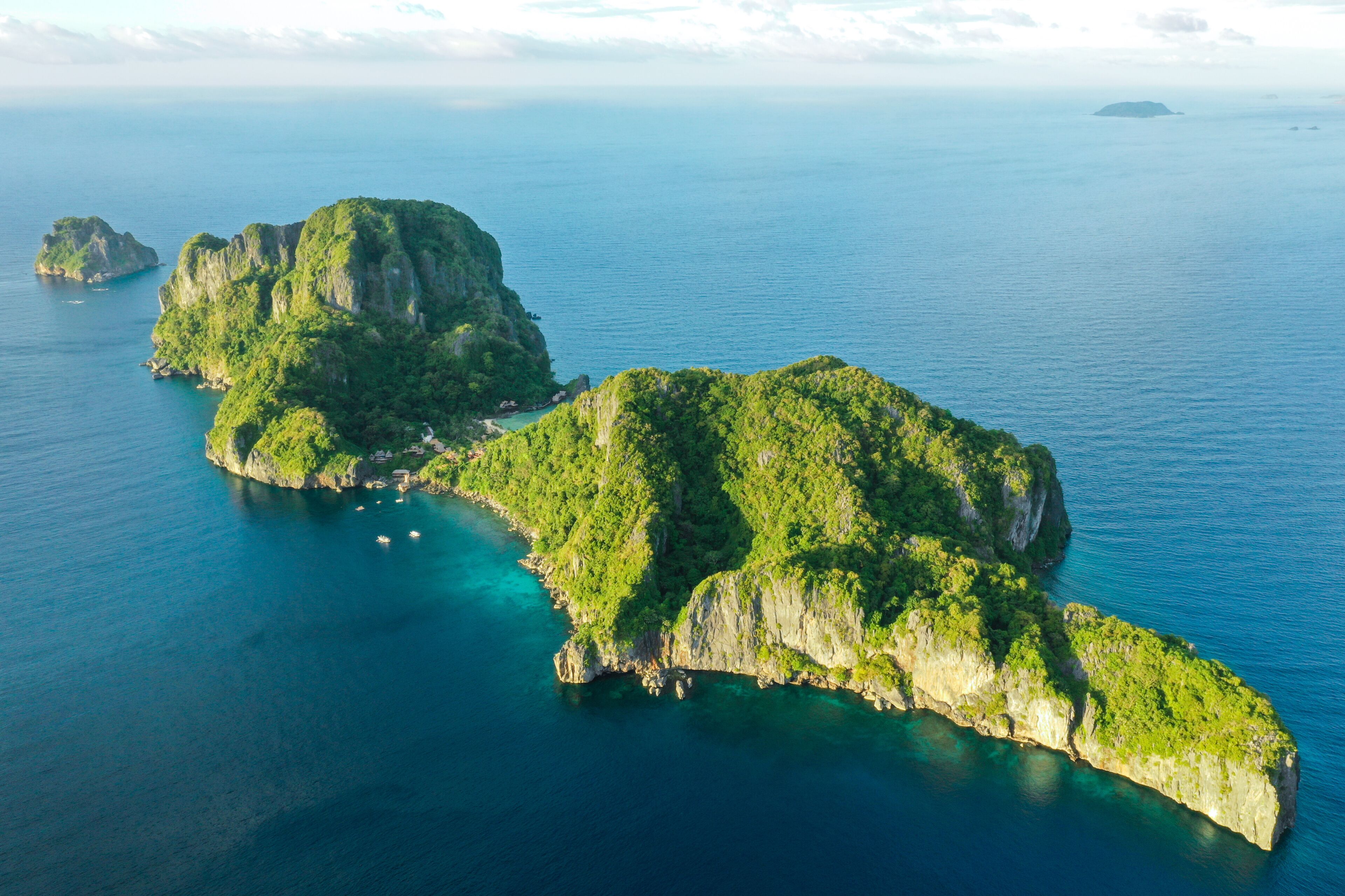 Aerial drone view of turquoise coastal waters in El Nido archipelago tourist destination of Cauayan Island. El Nido, Palawan, Philippines.