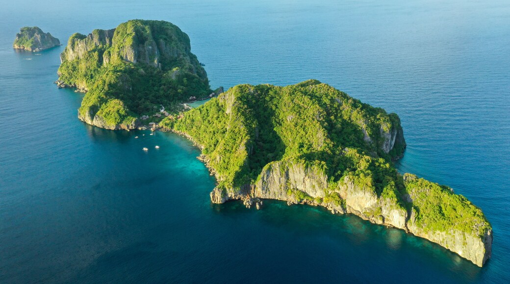 Aerial drone view of turquoise coastal waters in El Nido archipelago tourist destination of Cauayan Island. El Nido, Palawan, Philippines.