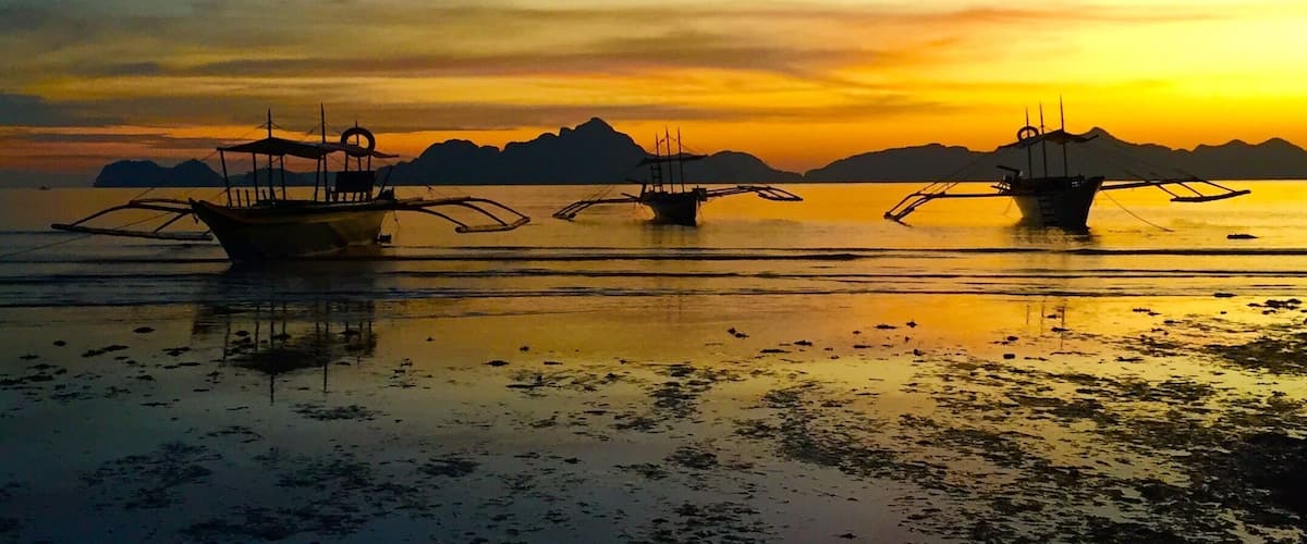 Sunset after a light rain ,passenger "bangkas" resting after another day of touring the islands