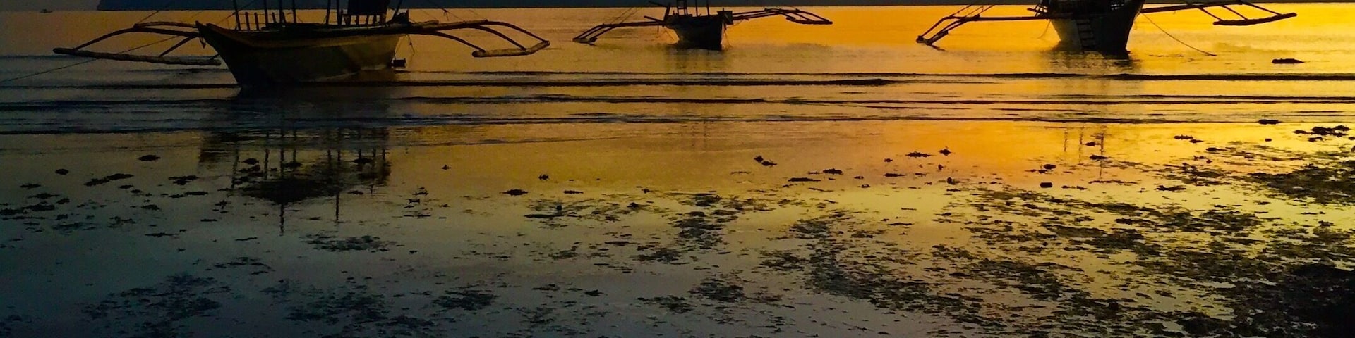 Sunset after a light rain ,passenger "bangkas" resting after another day of touring the islands
